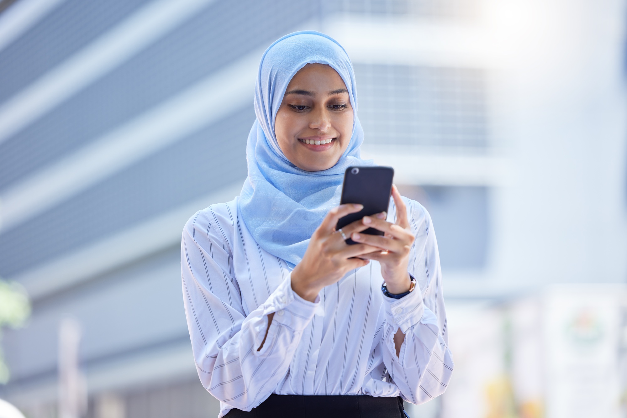Islam, islamic or business woman on her phone in hijab texting in the city with mockup. Diversity, Islam, islamic or business woman on her phone in hijab texting in the city with mockup. Diversity,